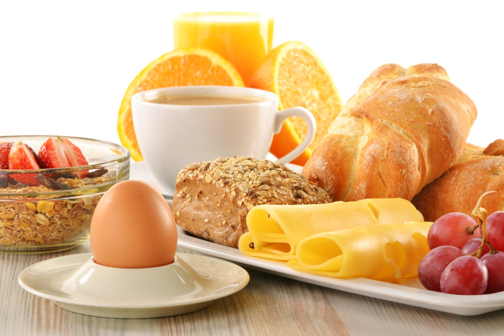 Breakfast with coffee, rolls, egg, orange juice, muesli and chee