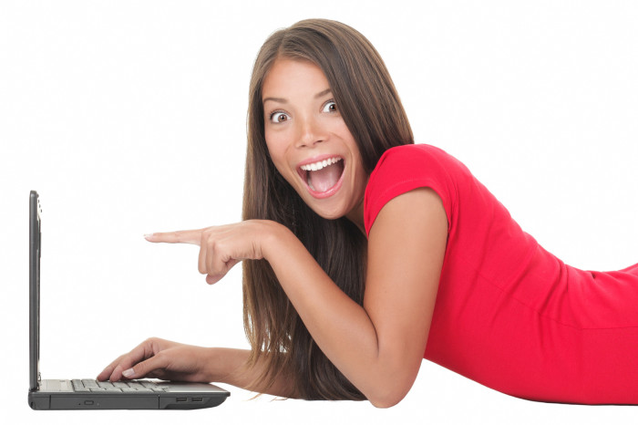 Woman excited with laptop