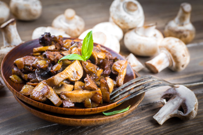 Fresh champignons on a wooden board