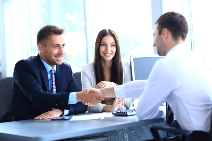businessman shaking hands to seal a deal with his partner